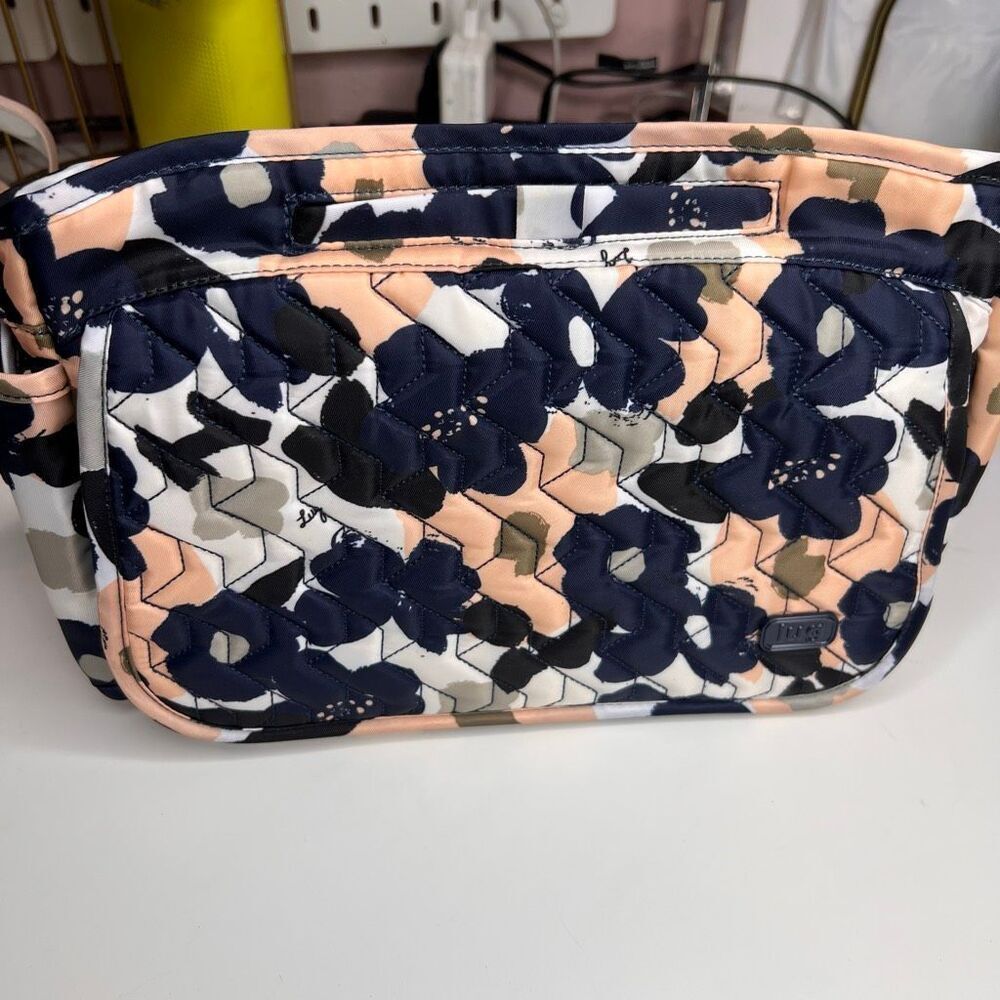 The item shown is a Lug Wings SE Crossbody bag in a floral pattern